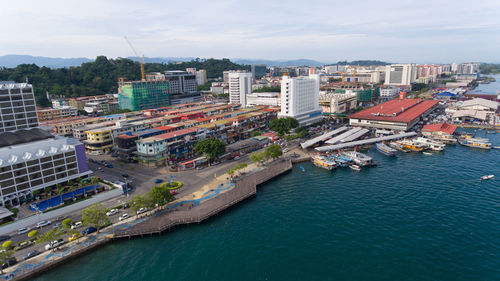 High angle view of buildings by sea against sky