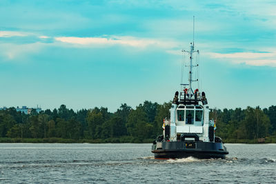 Boat sailing on sea against sky
