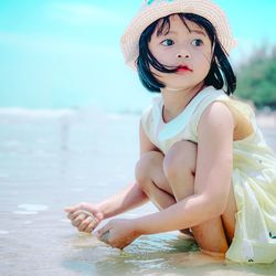 Portrait of cute girl sitting in water