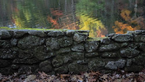 View of stone wall by rocks