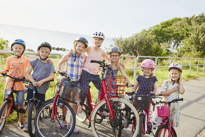 Children standing with bicycles