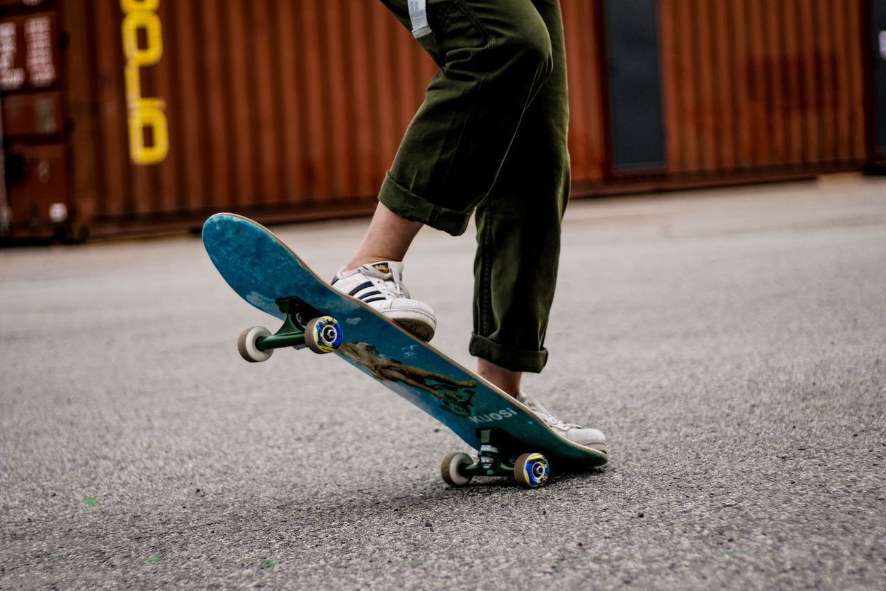 low section, skateboard, one person, real people, human leg, men, body part, sports equipment, sport, day, lifestyles, motion, leisure activity, human body part, balance, skill, street, city, shoe, human foot, human limb