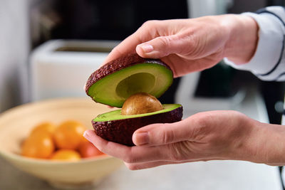 Woman hold fresh ripe avocado, healthy food and dieting concept, organic product