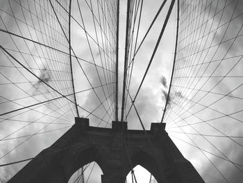 Low angle view of bridge against cloudy sky