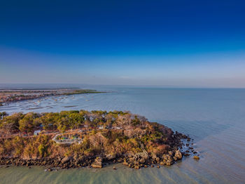 Scenic view of sea against blue sky