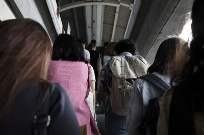 Low angle view of people standing on escalator