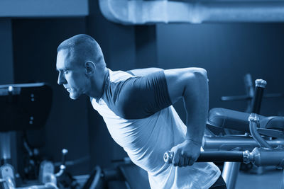 Side view of man exercising in gym