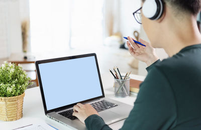 Low angle view of man using laptop on table