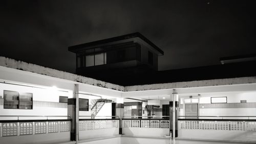 View of railroad station platform against sky at night