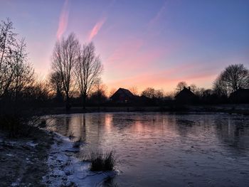 Scenic view of lake at sunset