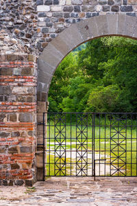 View of arch gate against brick wall