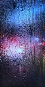 Full frame shot of wet glass window in rainy season