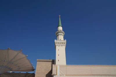 Low angle view of tower against blue sky