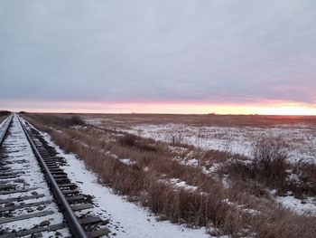 Scenic view of snow field against sky during sunset