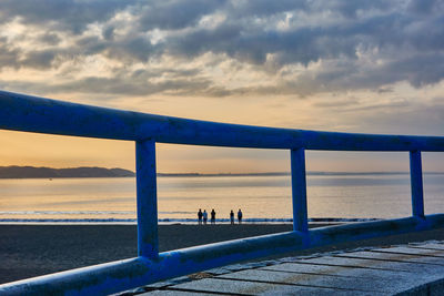 Pier over sea against sky during sunrise