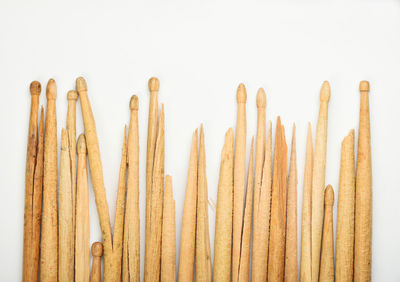 Close-up of wooden object over white background