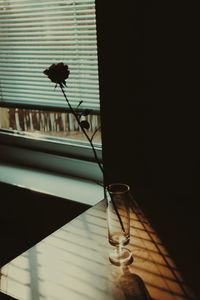 Close-up of glass window on table against building