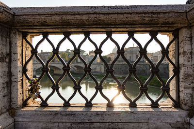 Metal fence against building