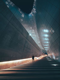 Man walking in illuminated tunnel