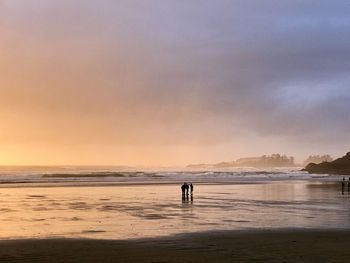 Scenic view of beach against sky during sunset