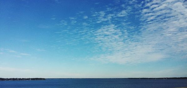 Scenic view of sea against blue sky