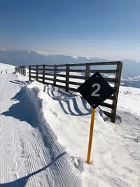 Scenic view of snow covered land against sky