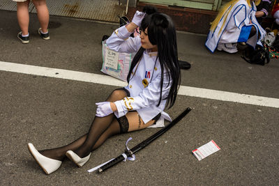 High angle view of women sitting on road