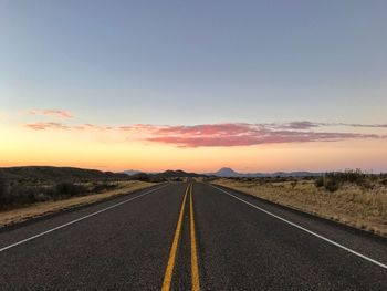 Road against dramatic sky during sunset