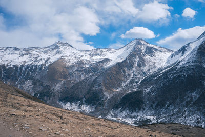 Scenic view of snowcapped mountains against sky