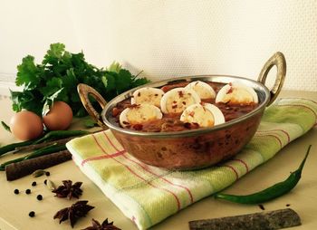 Egg curry and spices on table