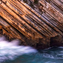 Low angle view of water flowing through rocks