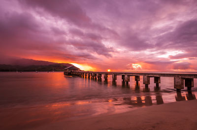 Hawaii  hanalei pier scenic view of sea against romantic sky at sunset