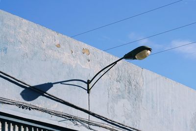 Low angle view of street light against sky