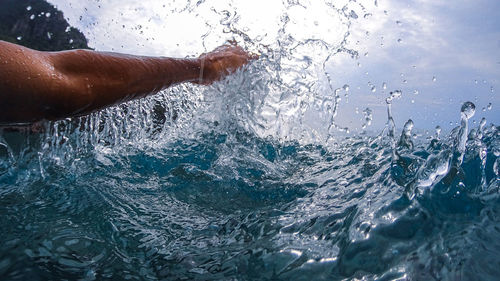 Wave splashing on person in sea
