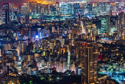 High angle view of illuminated buildings in city at night