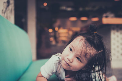 Portrait of cute girl looking away at home