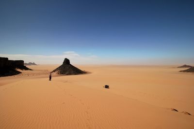 Sand dunes in desert against clear sky