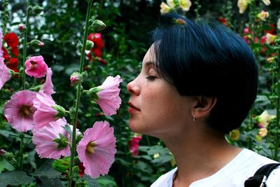 Portrait of woman with red flowers