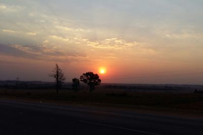 Scenic view of landscape against sky at sunset