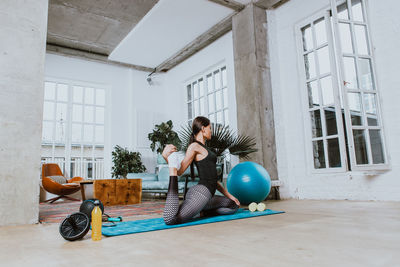 Young woman exercising at home