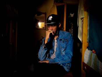 Young man smoking at home