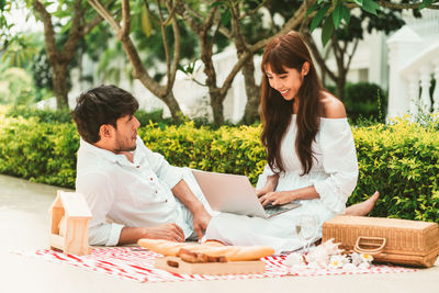 Young couple sitting on table