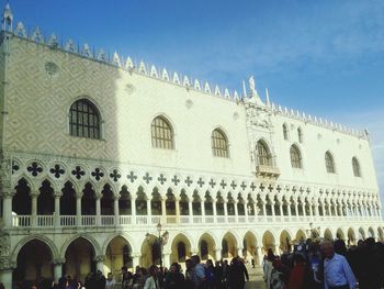 Silhouette of people in front of built structure