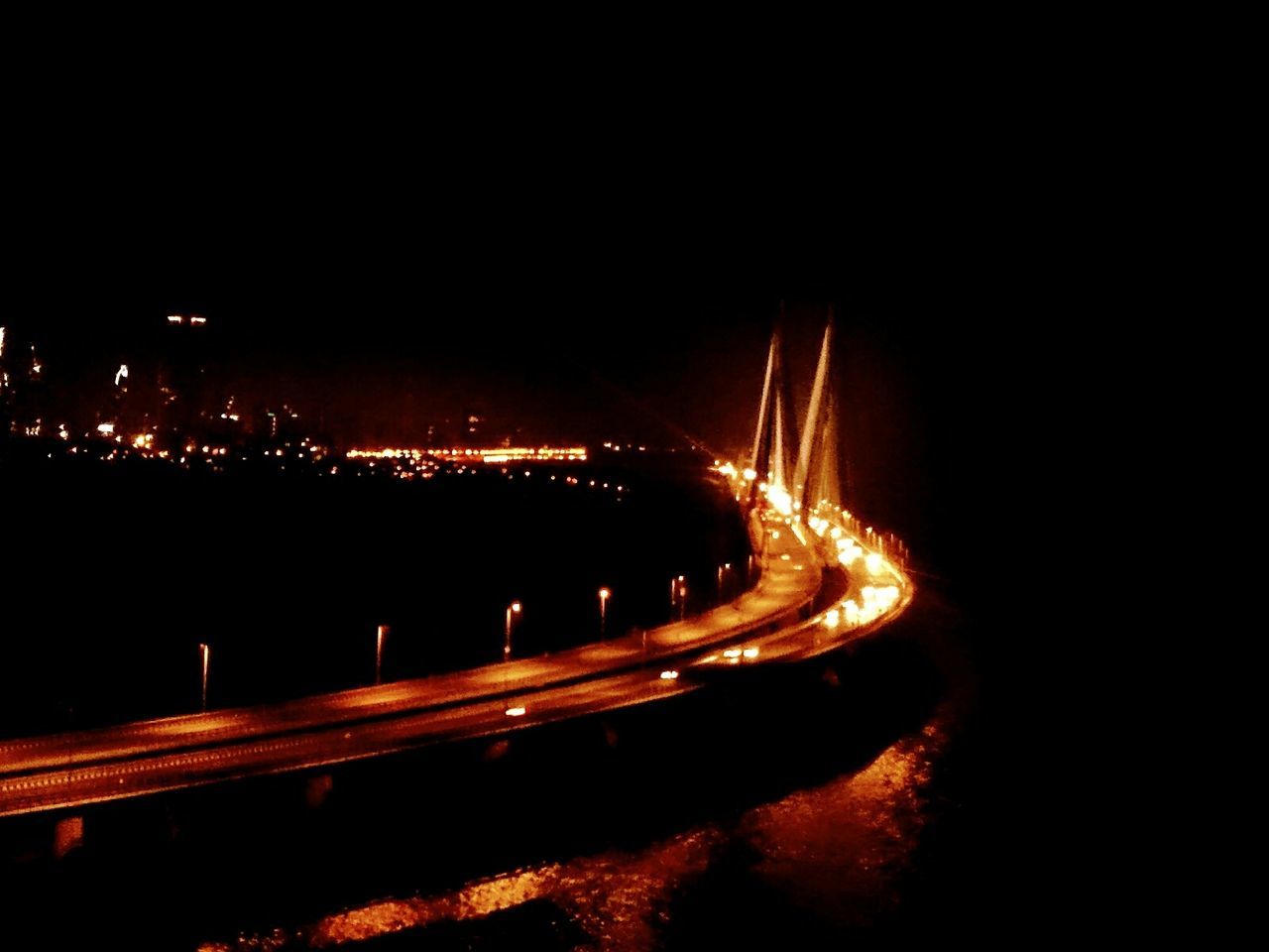 night, illuminated, long exposure, light trail, transportation, copy space, motion, speed, dark, blurred motion, connection, glowing, high angle view, built structure, bridge - man made structure, city, no people, clear sky, light - natural phenomenon, outdoors