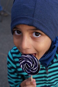 Portrait of boy licking lollipop