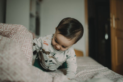 Cute boy on bed at home