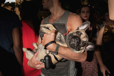 Portrait of man holding dog