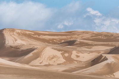 View from nature and landscapes of dasht e lut or sahara desert after the rain with wet sand dunes