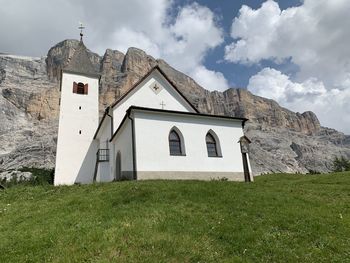 Building on field against sky