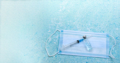 High angle view of syringe against white background
